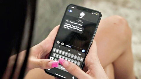 Step sister texting seductive bedtime message on phone, close-up hands