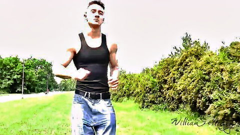 Muscular Bradley Cook jogging in tank top and jeans outdoors