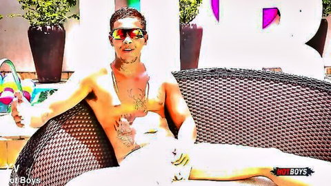 Ricc Villarim muscular Latino hunk poolside in sunglasses and shorts