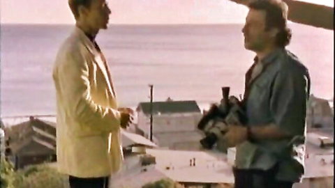Retro XXX scene with two men on seaside balcony, big tits and anal implied
