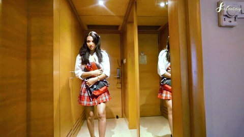 Desi Indian schoolgirl in sexy plaid skirt and blouse in hallway tease