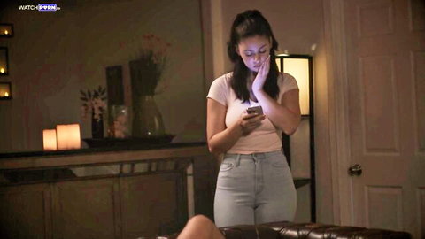 Ellie Nova in tight white tank top and jeans, teasing with phone
