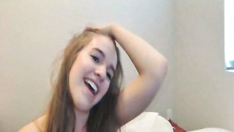 Smiling blonde babe posing topless on live cam