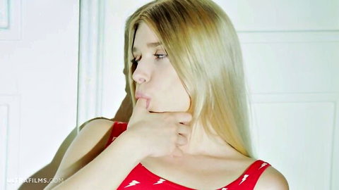 Blonde model Freya Mayer in red dress, thoughtful pose teasing viewers