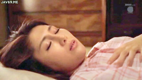 Sexy Asian babe lying asleep in bed with open plaid shirt teasing deep cleavage and tits