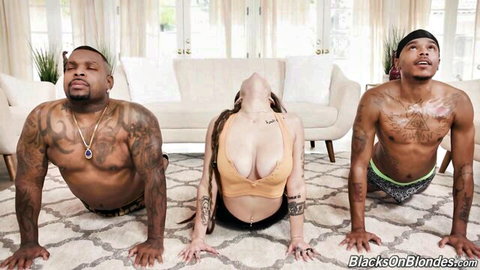 Indica Flower in arched yoga pose with two black men on couch