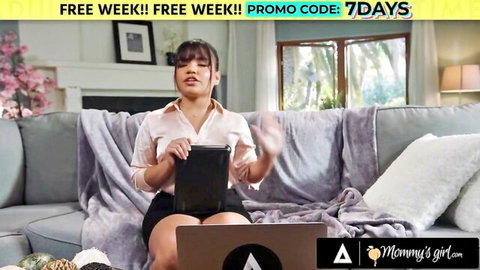 Petite Asian Summer Col in blouse and skirt on couch with laptop