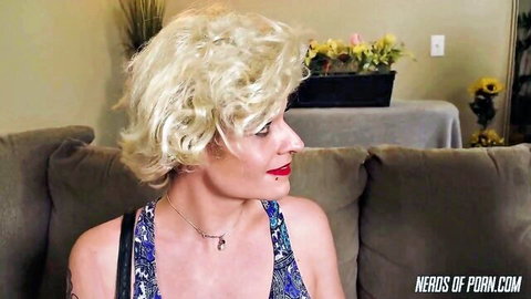 Blonde MILF in colorful top, seductive profile view for domination parody