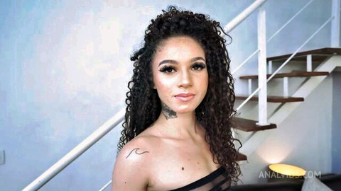 Bruna Santos in sexy black top, curly hair, teasing cleavage pose