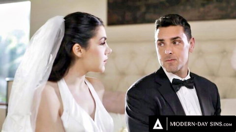 Valentina Nappi as bride in white dress with groom on wedding night bed