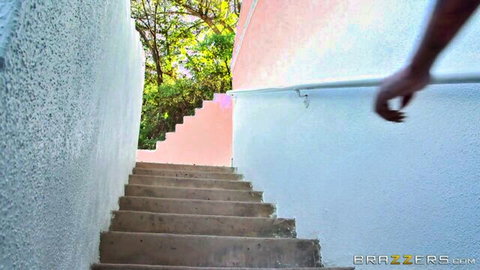 Bella Bellz hand on railing approaching colorful outdoor stairs
