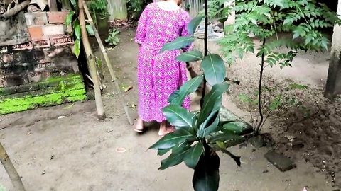 Hot Desi stepmom in pink floral dress walking outdoors