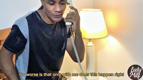 Man in shiny shirt talking on phone by lamp with 'Lady Milk' text overlay