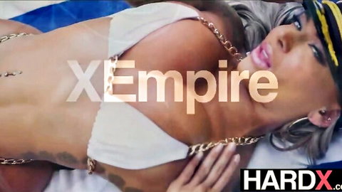 Hayley Davies in white chain bikini and captain hat, posing seductively