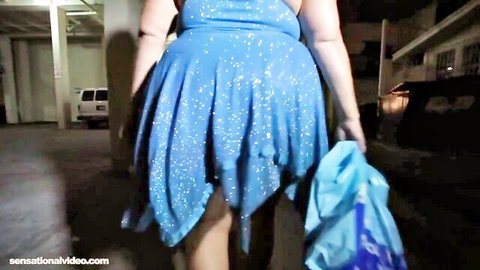 Peach Larue in sparkly blue dress walking in parking garage