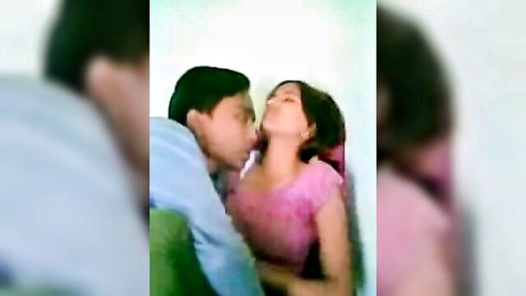 Indian couple passionately kissing as he tries to undress her pink top