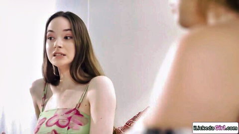 Young Asian stepdaughter in floral dress mirrors pose in lesbian MILF scene