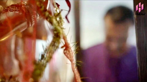 Blurry Indian man in purple with festive garlands, teasing teen lingerie encounter