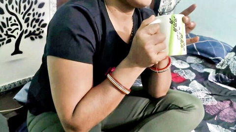 Desi woman in casual black top and pants, holding mug with bangles, bedroom tease from XXX Soniya