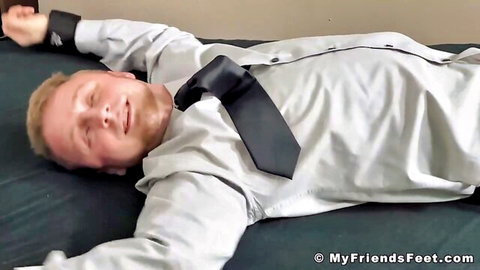 Athletic blond amateur restrained in shirt and tie, smiling for tickle fetish fun