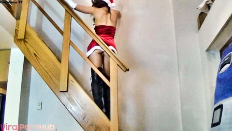 Brunette Santa babe climbs stairs in red mini dress flashing bare ass and shaved pussy