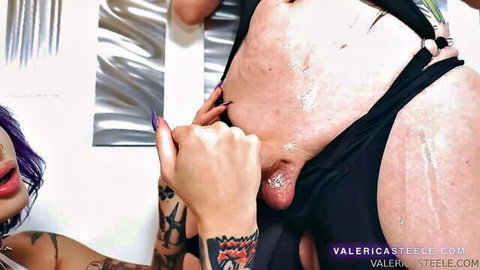 Tattooed purple-haired trans babe grips massive hard cock and balls in black jockstrap