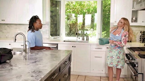 Blonde MILF Danielle Renae in floral dress chats with man in kitchen