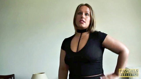 Ashley Rider in black choker top showing huge naturals cleavage, dominant pose