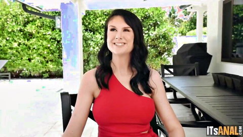 Sienna Rae smiling in sexy red one-shoulder dress outdoors