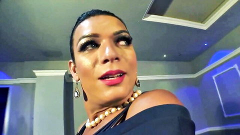 Seductive ebony woman in off-shoulder black dress, bold makeup and jewelry
