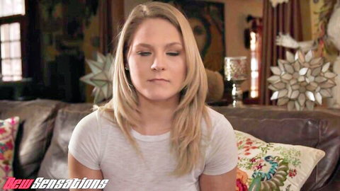 Blonde Lisey Sweet in white t-shirt sitting thoughtfully