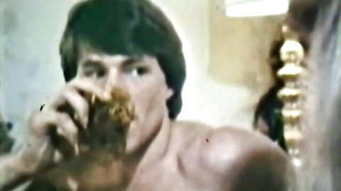 Muscular shirtless hunk with shaggy hair eats thick brown turd from his hand closeup