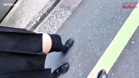 Sexy schoolgirl in short black pleated skirt and thigh-high socks walks street teasing upskirt view
