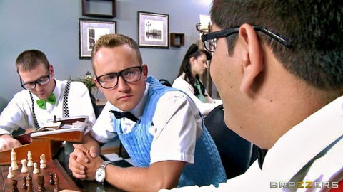 Nerdy guys in bowties and glasses playing chess at classroom table with hot babe nearby