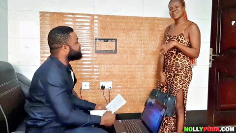Ebony woman in tight leopard mini dress stands smiling over suited black man holding papers and laptop