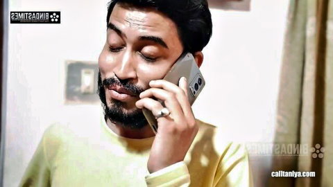 Handsome Indian man with beard on phone, teasing 3some with girlfriend and BF's GF