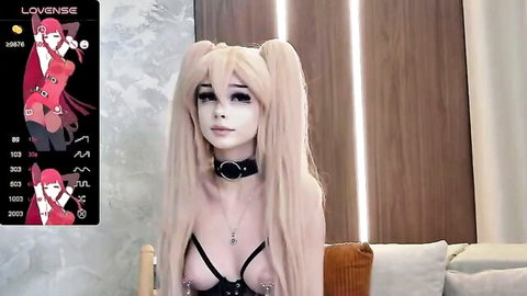 Blonde Mistress Xenomy in revealing cosplay harness exposing tits on webcam