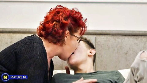 Redhead stepmom with glasses kisses young stepson passionately