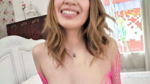 Suzuna Komiya smiles seductively in pink fishnet top, JAV solo tease