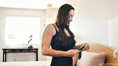 Karlee Grey in black tank top holding tie for lesbian domination with Vanna Bardot