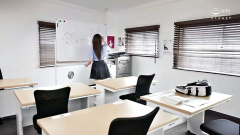 Asian teacher in short plaid skirt writes on classroom board, teasing uniform fetish
