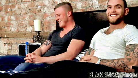 Liam Lawrence and muscular buddy smiling on bed, ready for mutual jerk off session