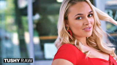 Blonde bombshell in tight red dress showing off cleavage and curves