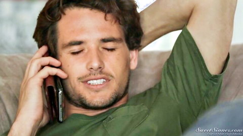 Yhivi's lover lounging relaxed on phone call, curly hair guy in green shirt