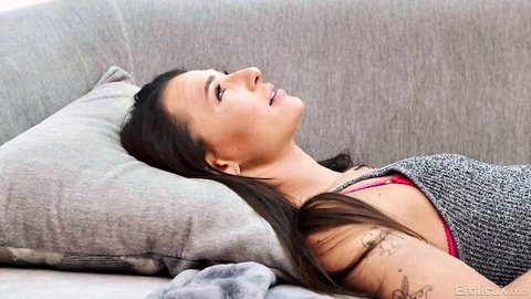 Liz Jordan lying sensually in gray top and pink lingerie, erotic thumbnail