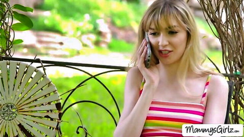 Blonde Natalie Knight seductively talks on phone in striped top, previewing lesbian threesome with stepmom