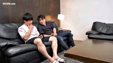 Two Asian men in casual attire lounging and checking phone, JAV story setup