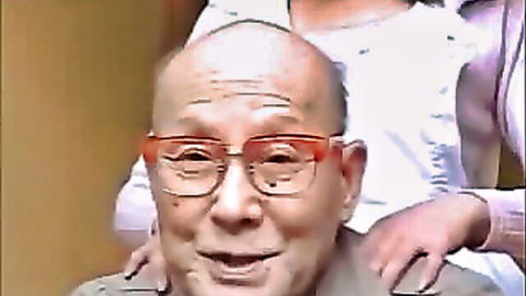 Smiling bald Asian elder in red glasses with woman hands on shoulders