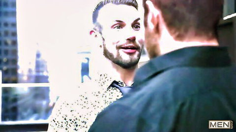 Two athletic white gay men with short hair talking intimately face-to-face in shirts on urban balcony