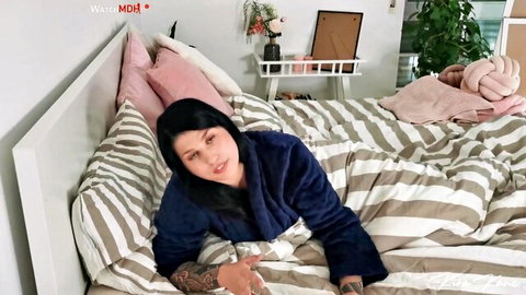 Kira Kane in blue bathrobe, lying on bed, teasing POV style